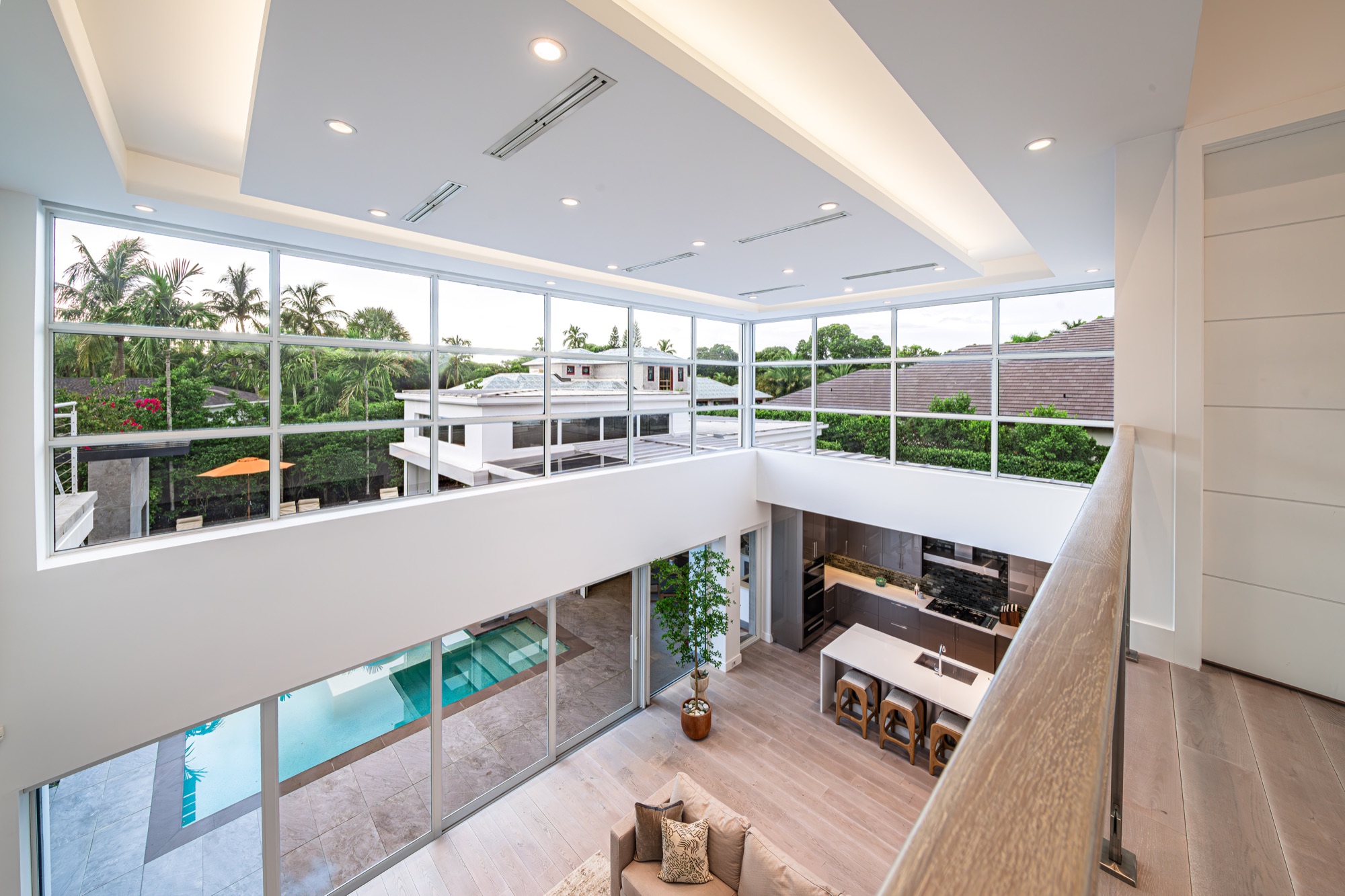 Double-height living space viewed from the mezzanine of a Coquina Sands residence in Naples