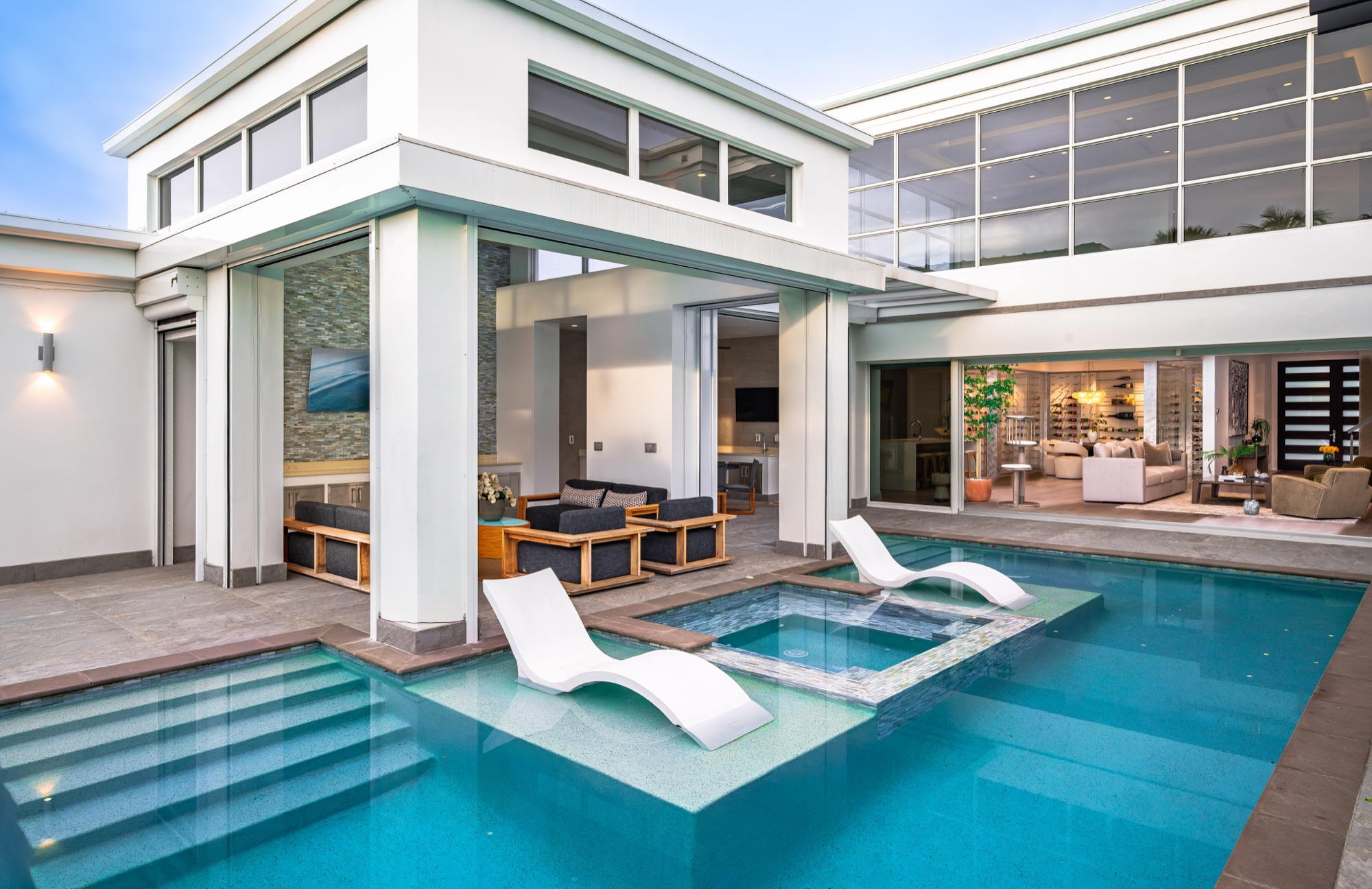 Modern pool courtyard opening into a Coquina Sands residence in Naples